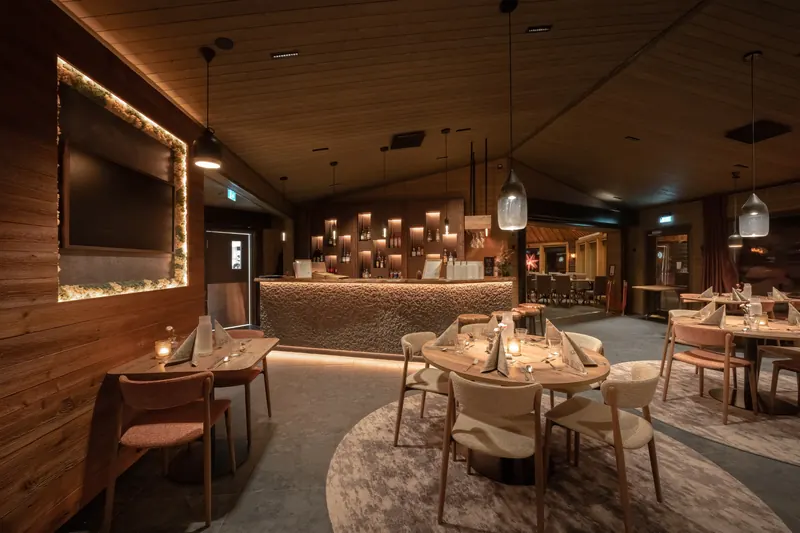 A warmly lit lounge and restaurant set for the evening