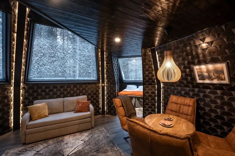 A dark wooden suite with a sofa and two armchairs